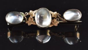 A silver gilt brooch set with three moonstones and ivy decoration