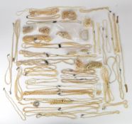 A large collection of faux pearls including some with silver Art Deco clasps