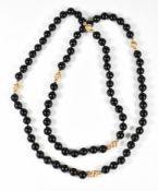 A necklace of onyx beads interspersed with 9ct gold beads