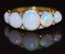 A c1900 18ct gold ring set with five opal cabochons and rose cut diamonds, 4.9g, size O