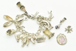 Silver charm bracelet with nineteen charms including message in a bottle, wise owl, tea pot,