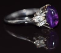 An 18ct white gold ring set with an amethyst cabochon, marquise cut diamonds and baguette cut