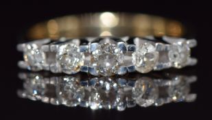 An 18ct gold ring set with five diamonds, the centre diamond approximately 0.21ct, 5.0g, size P