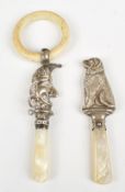Two hallmarked silver baby's rattles comprising dog, Chester 1960, maker W H Collins & Co and a