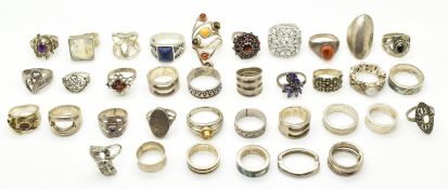 Thirty four silver rings including amethyst, pressed amber, labradorite, marcasite, etc