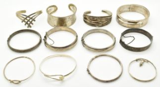 Twelve silver bangles including engraved examples