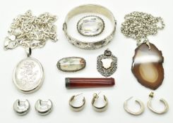 A silver bangle set with garnets, silver locket c1910 with engraved floral decoration, three pairs