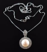 A silver pendant set with a pearl surrounded by diamonds on a silver chain