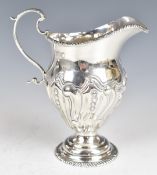 Victorian hallmarked silver jug with embossed decoration, London 1895, maker's mark rubbed, height