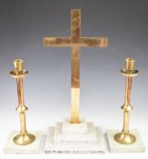 Ecclesiastical bronze cross and candlestick garniture raised on stepped and flat marble bases, the
