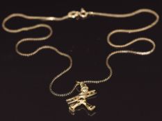 A 14k gold pendant in the form of a man carrying a ladder, on a 14k gold chain, 3.4g