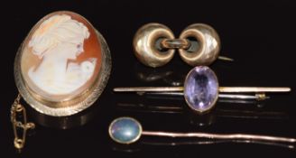 A 9ct gold brooch set with an amethyst, a 9ct gold stick pin set with an opal doublet (5g), 9ct gold