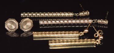 Three pairs of 9ct gold earrings including octagonal engine turned, pierced drop earrings and one