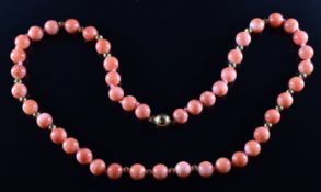A necklace of coral and 18ct gold beads with 18ct gold clasp