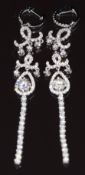 A pair of 18ct white gold earrings set with a diamond of approximately 0.4ct and a quantity of