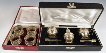 Cased set of four silver napkin rings with embossed decoration and marked sterling silver,