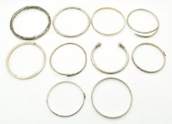 Eight silver bangles including two in the form of snakes, a silver flapper bangle in a bamboo design