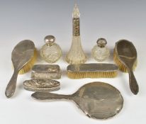 Hallmarked silver mounted items comprising hand mirror, three brushes, four silver topped dressing