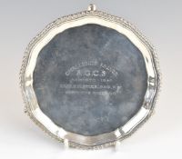 George V hallmarked silver card tray with gadrooned edge, raised on three feet, with inscription