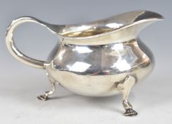 Edward VII hallmarked silver bachelor's milk jug, raised on three feet, Birmingham 1906, maker