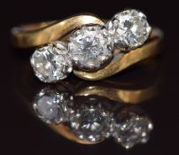 An 18ct gold ring set with three round brilliant cut diamonds in a twist setting, total diamond
