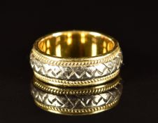 An 18ct bi-coloured gold ring with plaited and rope twist decoration, 7.7g, size L