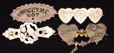 Four c1900 9ct gold brooches including 'Forget Me Not', 'Mizpah', horseshoe and heart and swallow,