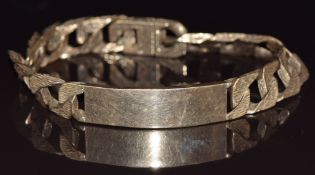 A 9ct gold curb link bracelet made up of textured links, Birmingham 1977, 56g