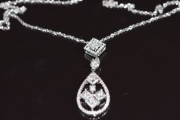 An 18ct white gold pendant set with four princess cut diamonds and further round brilliant cut