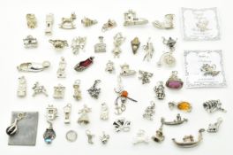 Over fifty silver / white metal charms including shoes, penny farthing by Nuno, clock, etc