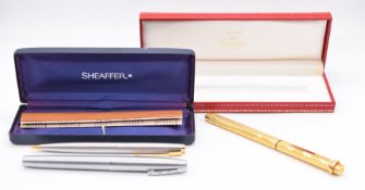 Must de Cartier ballpoint pen in original fitted case and a Sheaffer cased pen and pencil set with