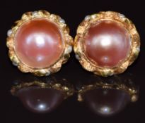 A pair of 18ct gold earrings each set with mabé pearls and further split pearls to the textured