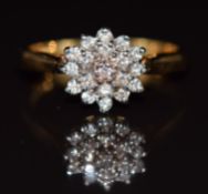 An 18ct gold ring set with a cluster of diamonds totalling 0.33ct, 4.1g, size O