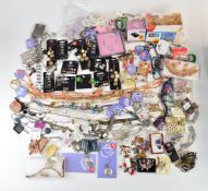 A collection of costume jewellery including earrings, brooches, necklaces, Swatch watch, etc