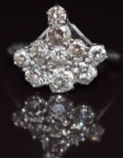 An 18ct white gold ring set with a cluster of old cut diamonds the largest approximately 0.28ct, 4.