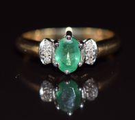 A 9ct gold ring set with an oval cut emerald and diamonds, 1.6g, size H