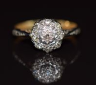 An 18ct gold ring set with diamonds in a platinum cluster setting, 2.7g, size K