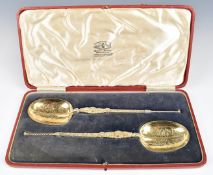 Cased pair of George V hallmarked silver gilt large anointing spoons, possibly to commemorate the