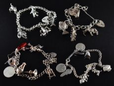 Four silver charm bracelets with over eighteen silver charms including car, fish, elephant, boat,