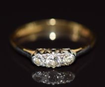 An 18ct gold ring set with three old cut diamonds in a platinum setting, 1.8g, size M