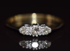 An 18ct gold ring set with three diamonds in a platinum setting, 2.2g, size R