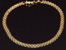 A 14k gold necklace made up of flat links forming a cross design, 39cm, 33.4g