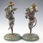 Pair of figural lead candlesticks formed as minotaurs, on green marble or similar base, height 26cm