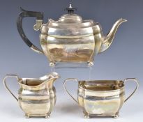 George VI hallmarked silver three piece teaset, each piece raised on four squat ball feet, Sheffield
