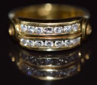 An 18ct gold bespoke ring set with diamonds in two channels and an additional diamond to each