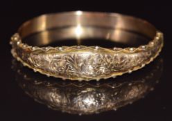 A 9ct rose gold bangle with scrolling rope twist and sphere decoration, Birmingham 1915, 9.4g