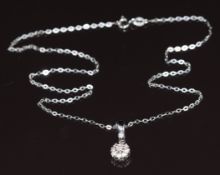 A 14k white gold pendant set with a cluster of diamonds, on 14k white gold chain, 3g