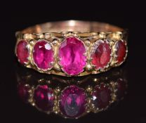 A 9ct gold ring set with synthetic rubies and tourmaline, Birmingham 1920, 2.5g, size N