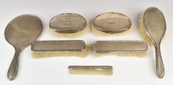 Hallmarked silver mounted dressing table items comprising hand mirror, five brushes and comb
