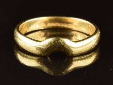 An 18ct gold wedding band / ring with cut out to fit another ring, 2.7g, size L